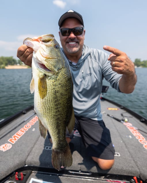 Mark Zona holds up a big largemouth he caught flippin