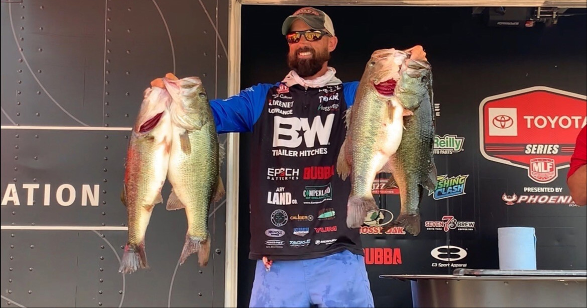 MLF Pro Kyle Cortiana on stage with 4 giant bass